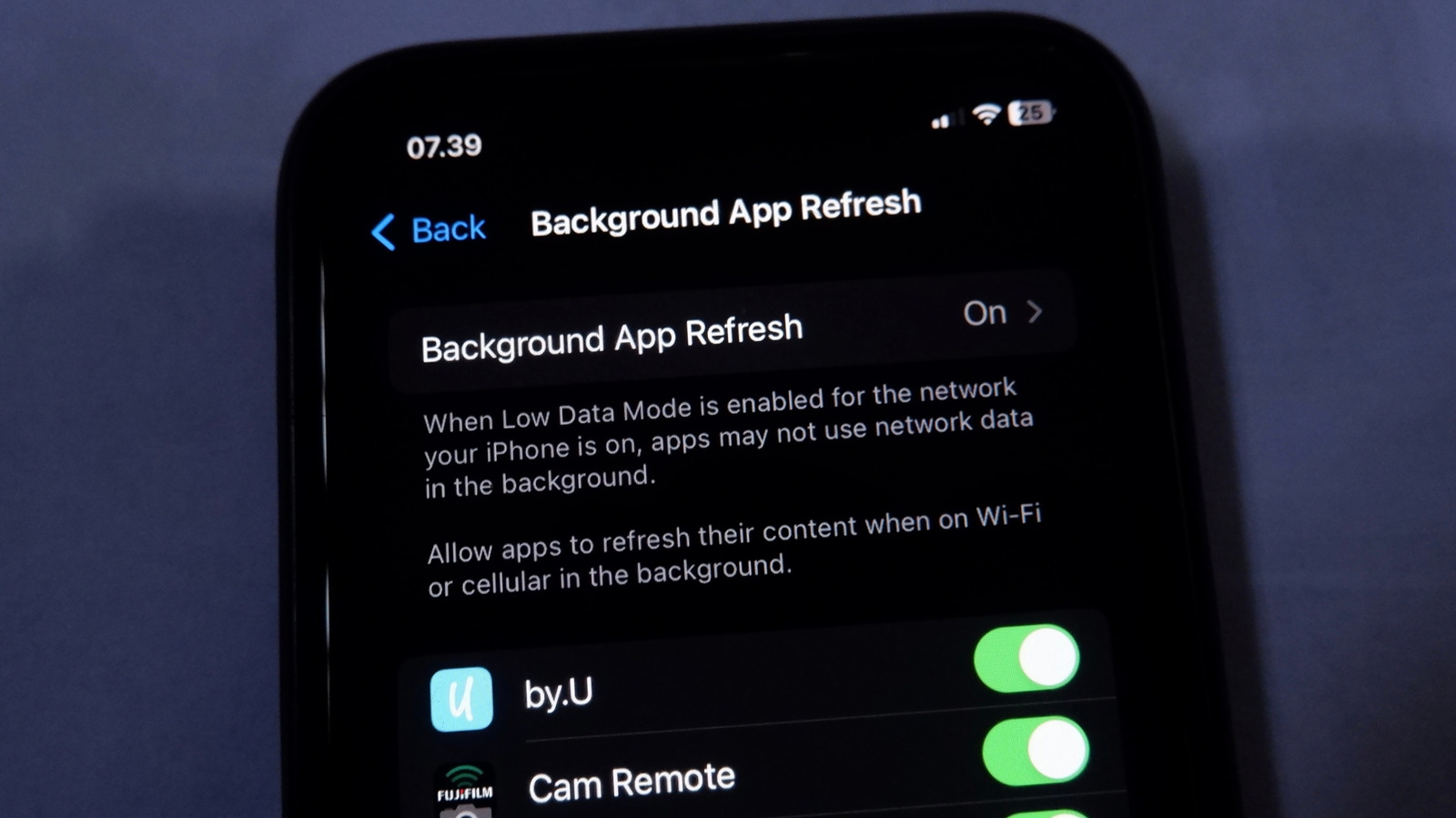 iPhone displaying the Background App Refresh settings page with app refresh toggles enabled