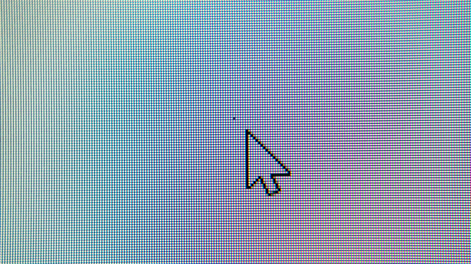 Close-up of a computer screen’s RGB pixel grid with a black mouse cursor visible.
