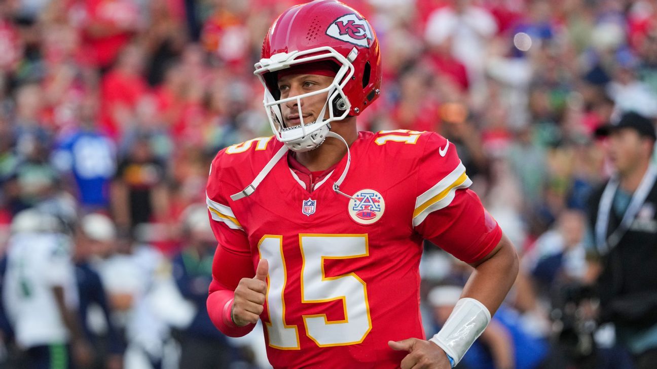 NFL quarterback wearing a red number 15 jersey and helmet runs during a game