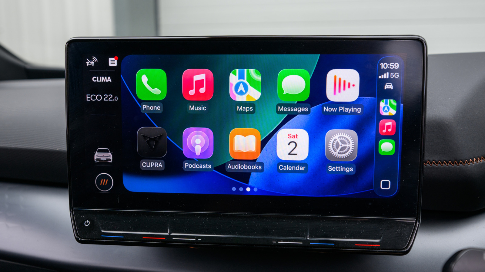 Car dashboard touchscreen displays Apple CarPlay apps, including Phone, Music, Maps, Messages, and Settings.