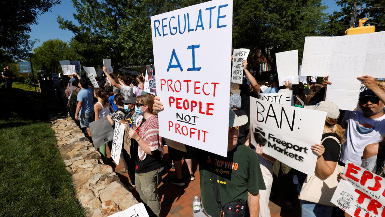 Crowd of demonstrators holding handmade signs calling for AI regulation and public protection.