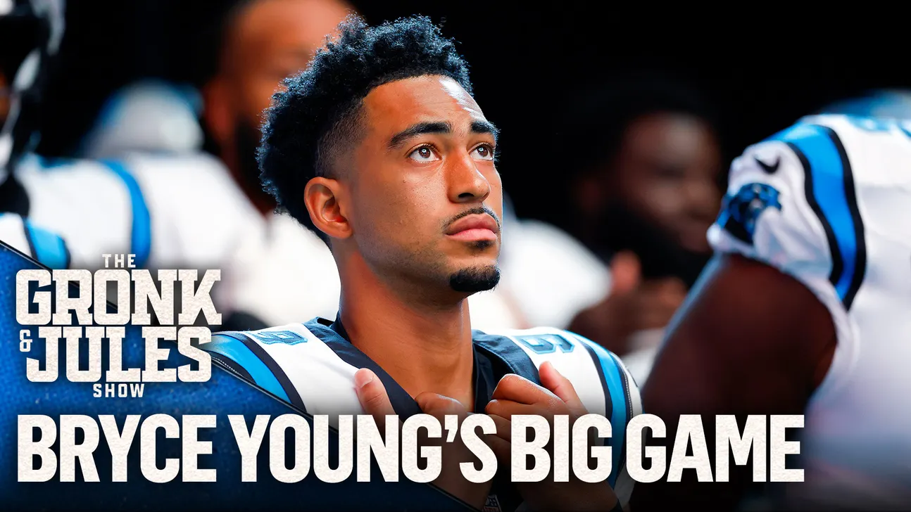 Football player in a Carolina Panthers uniform looks upward during a game.
