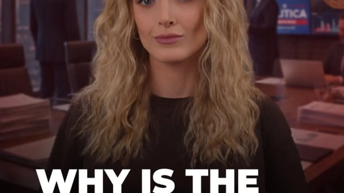 Blonde woman in a black top appears onscreen with large white text reading “WHY IS THE.”
