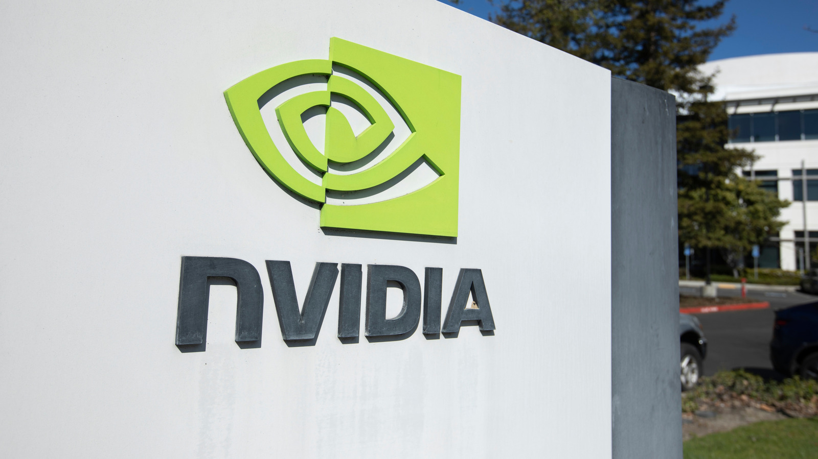 NVIDIA logo and lettering mounted on a white sign outside an office building