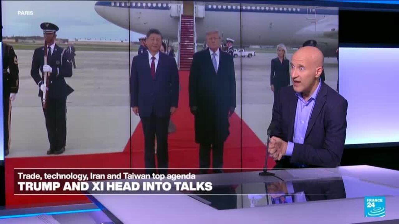 A news broadcast shows Trump and Xi standing on a red carpet as a presenter speaks in the foreground.
