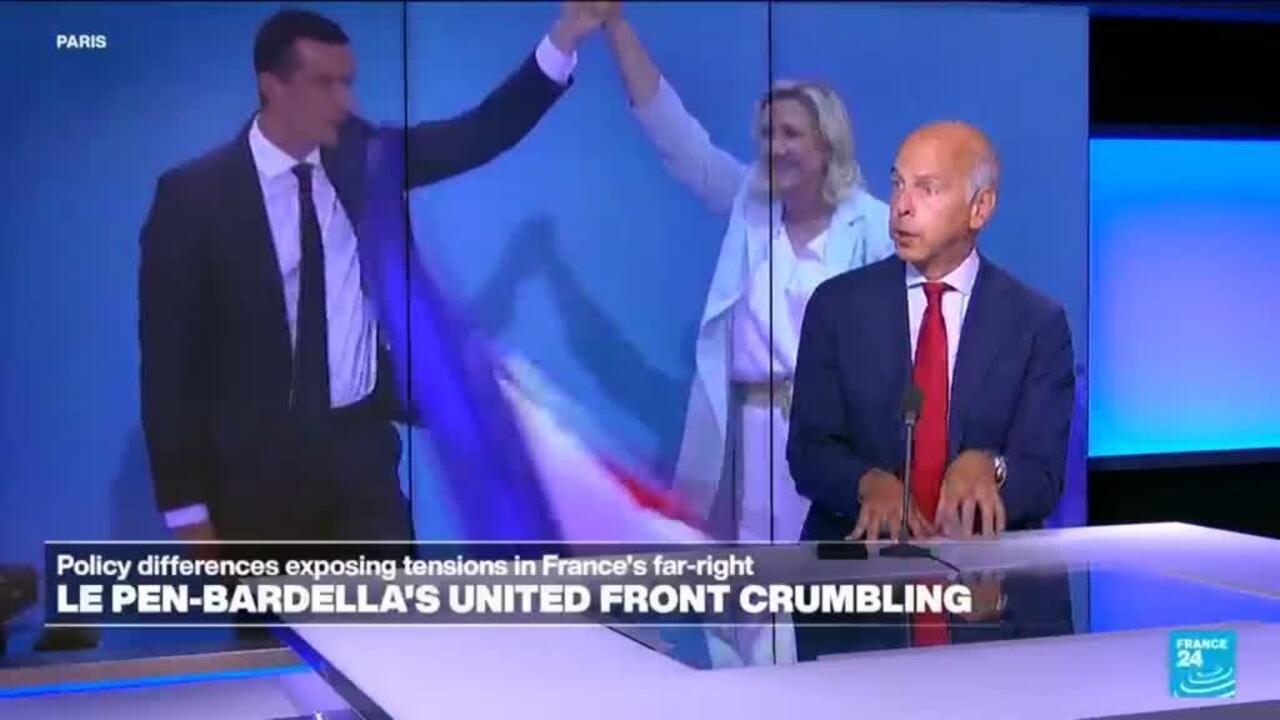 Television panel shows two suited politicians at a desk with France24 graphics and Le Pen-Bardella headline.