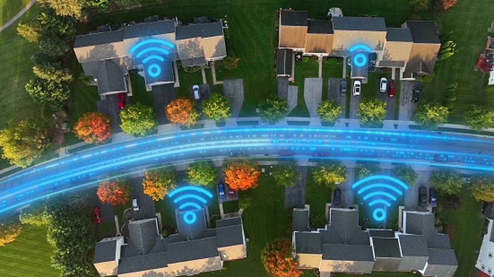 Aerial view of homes with glowing blue Wi-Fi symbols and a digitally illustrated network across the road