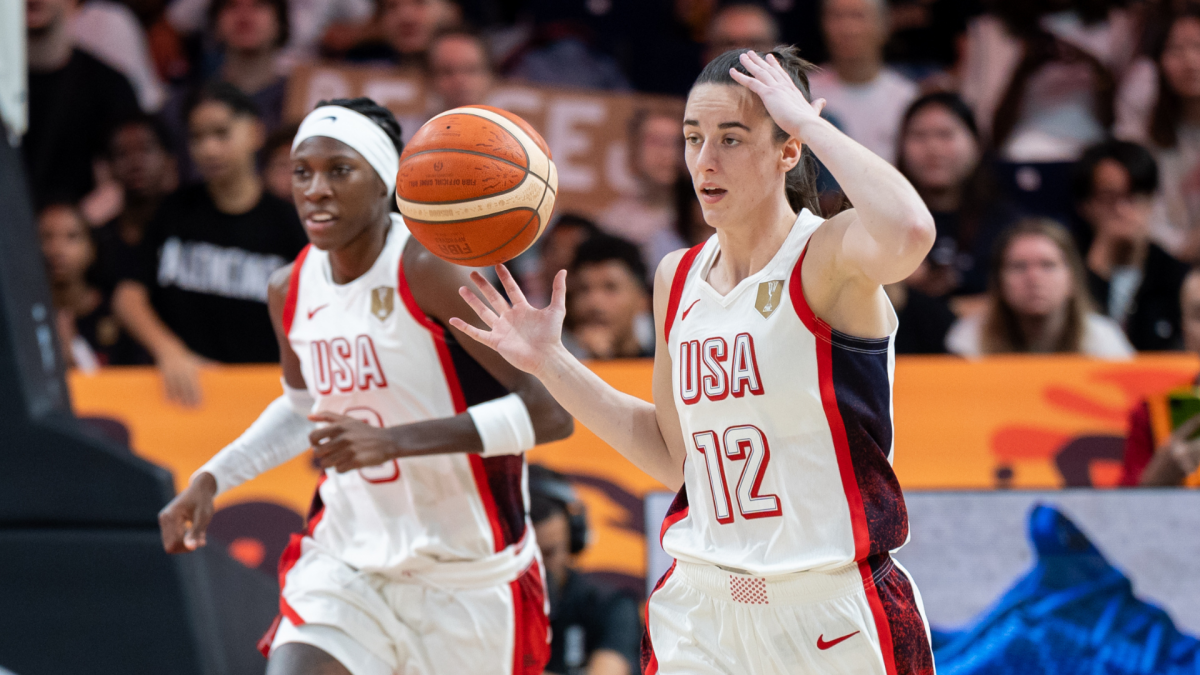 Two Team USA women’s basketball players move during a game, with one handling the ball.