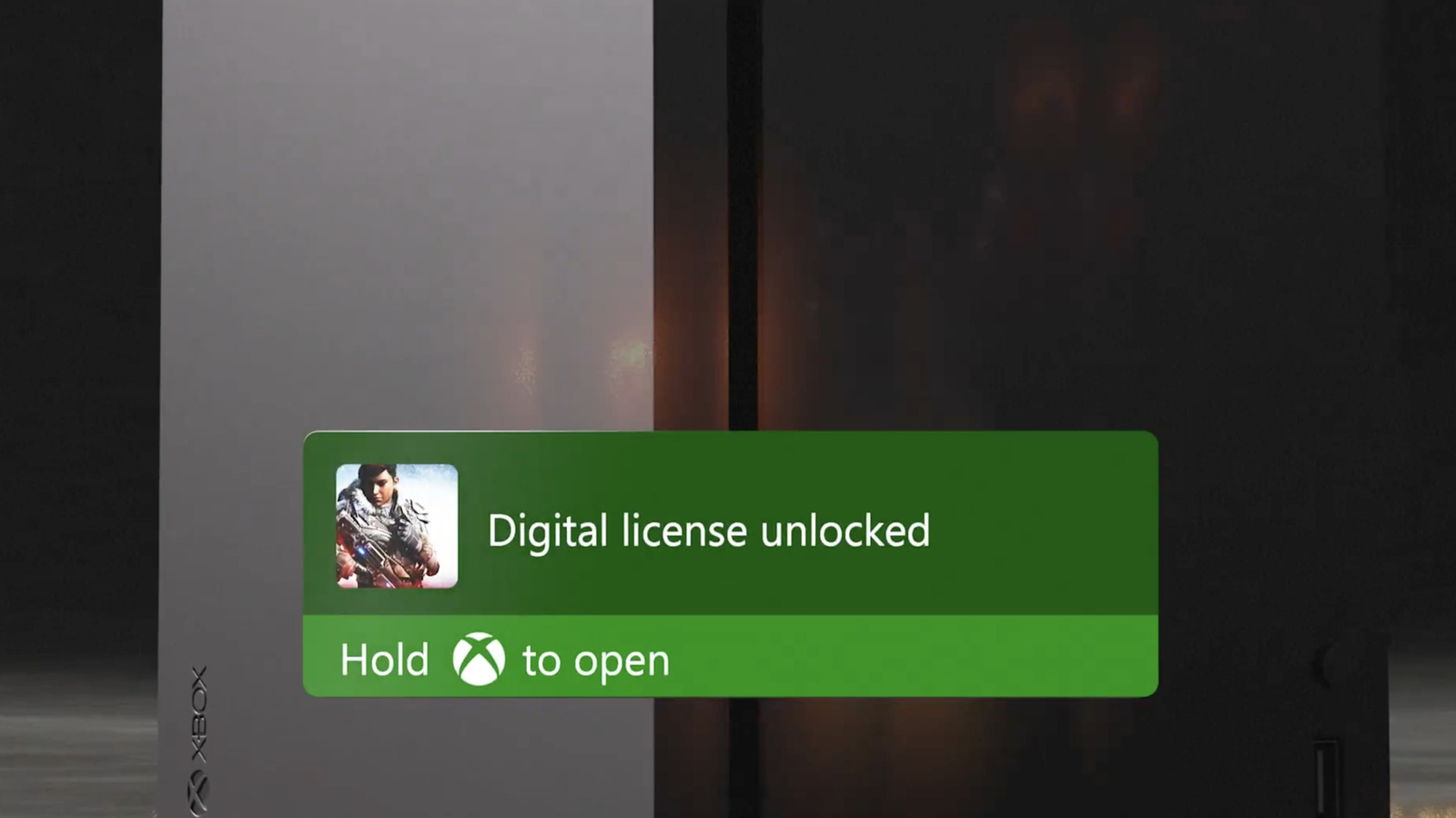 An Xbox console displays a green notification reading “Digital license unlocked” and “Hold Xbox to open.”