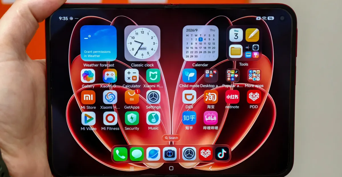 Xiaomi device displaying a colorful home screen with widgets and app icons, held in one hand