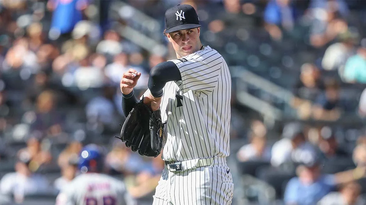Yankees pitcher in pinstriped uniform holding a glove during a game