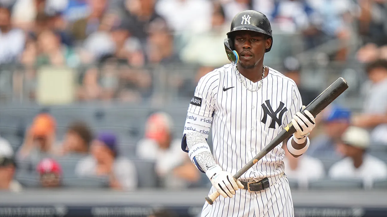 New York Yankees player Jazz Chisholm Jr. stands holding a bat during a game.