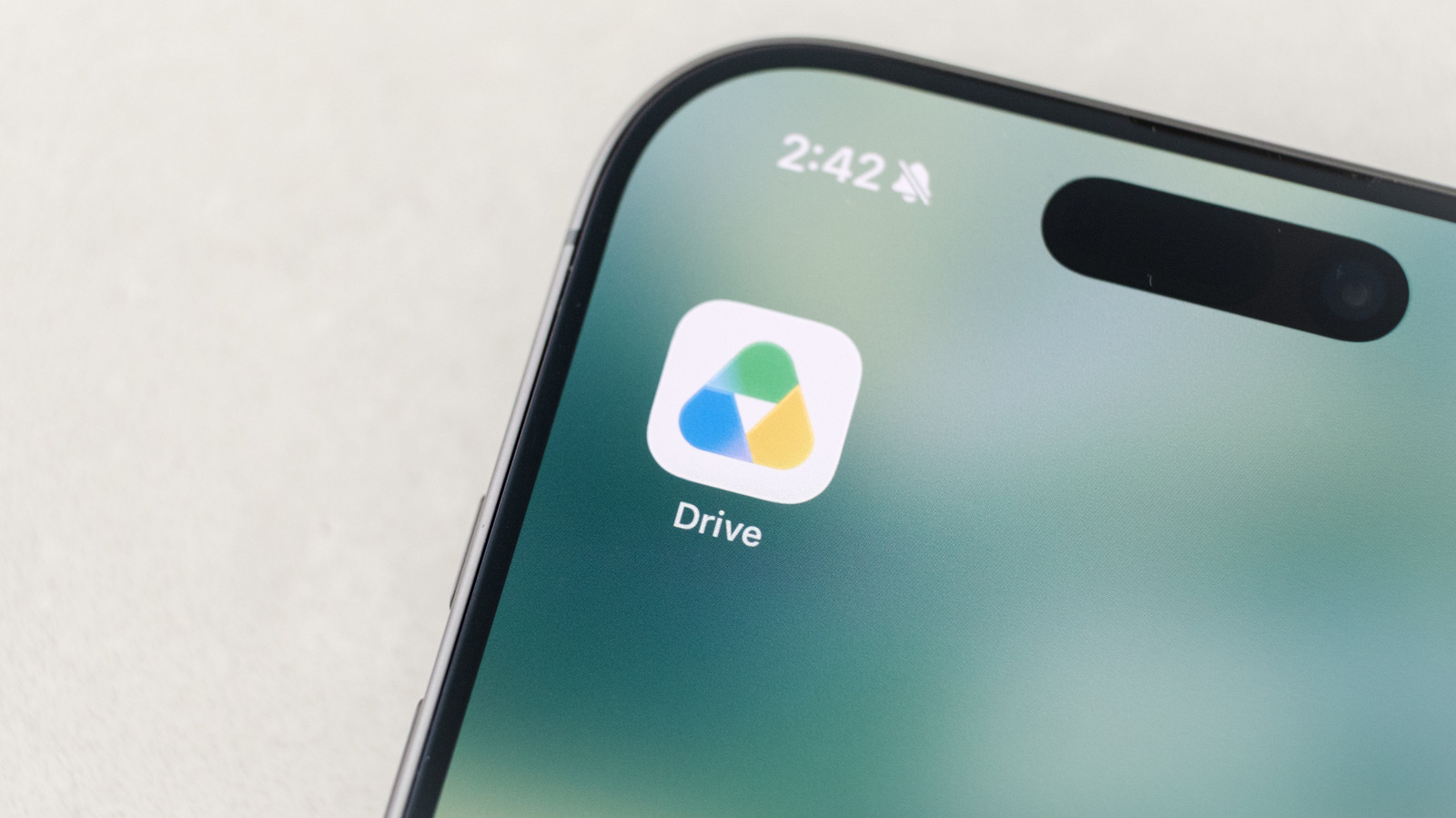 Close-up of a smartphone displaying the Google Drive app icon and label on its screen.