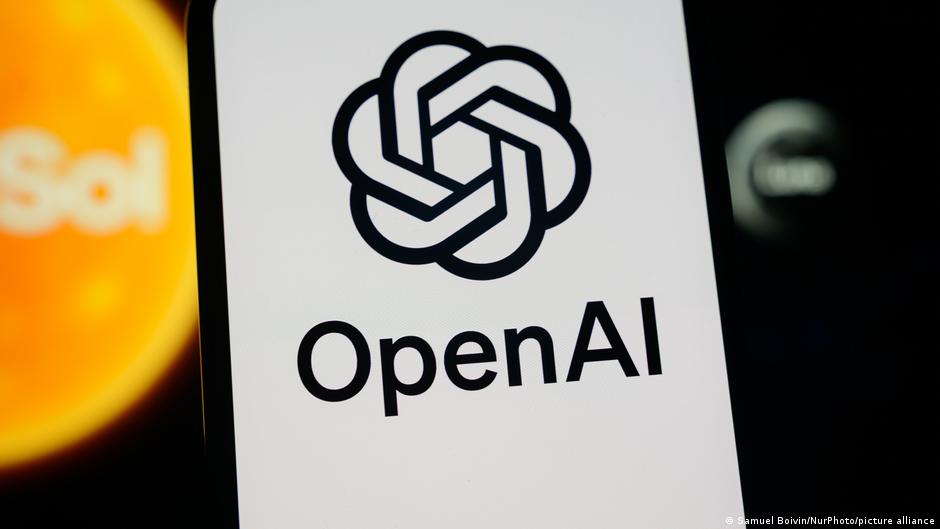OpenAI logo and wordmark on a white panel, with blurred orange and dark shapes in the background.