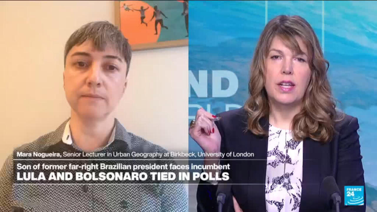 Split-screen broadcast shows a short-haired guest on the left and a female presenter on the right.