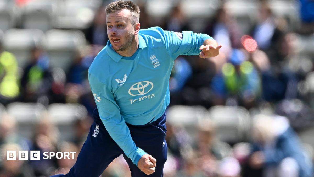 An England player in a blue training shirt bowls during a cricket practice session.