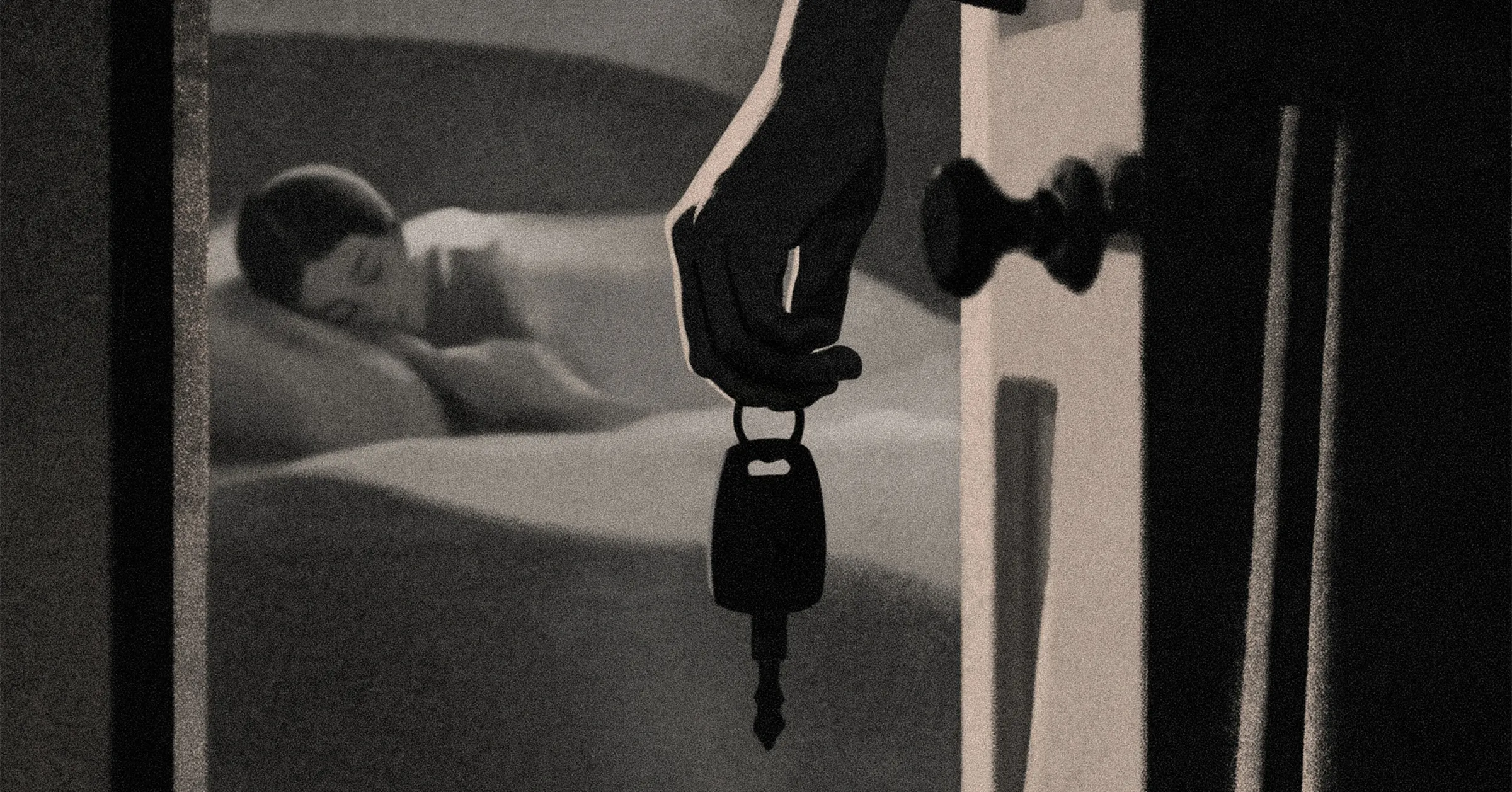 A dark hand holds a small device above a blurred person lying on a bed.