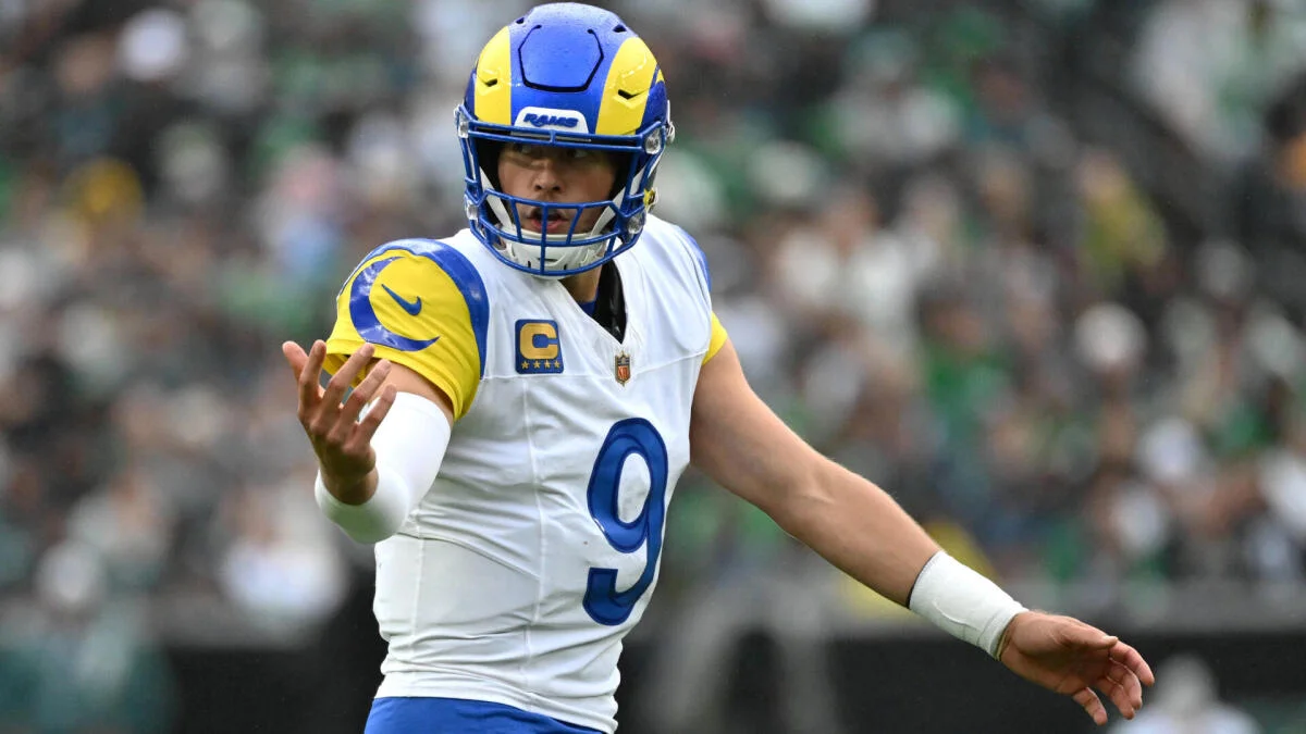 Los Angeles Rams quarterback in a white number 9 uniform gestures during a game.
