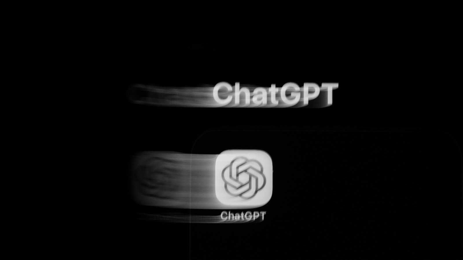 Blurred white ChatGPT wordmark and app icon against a black background.