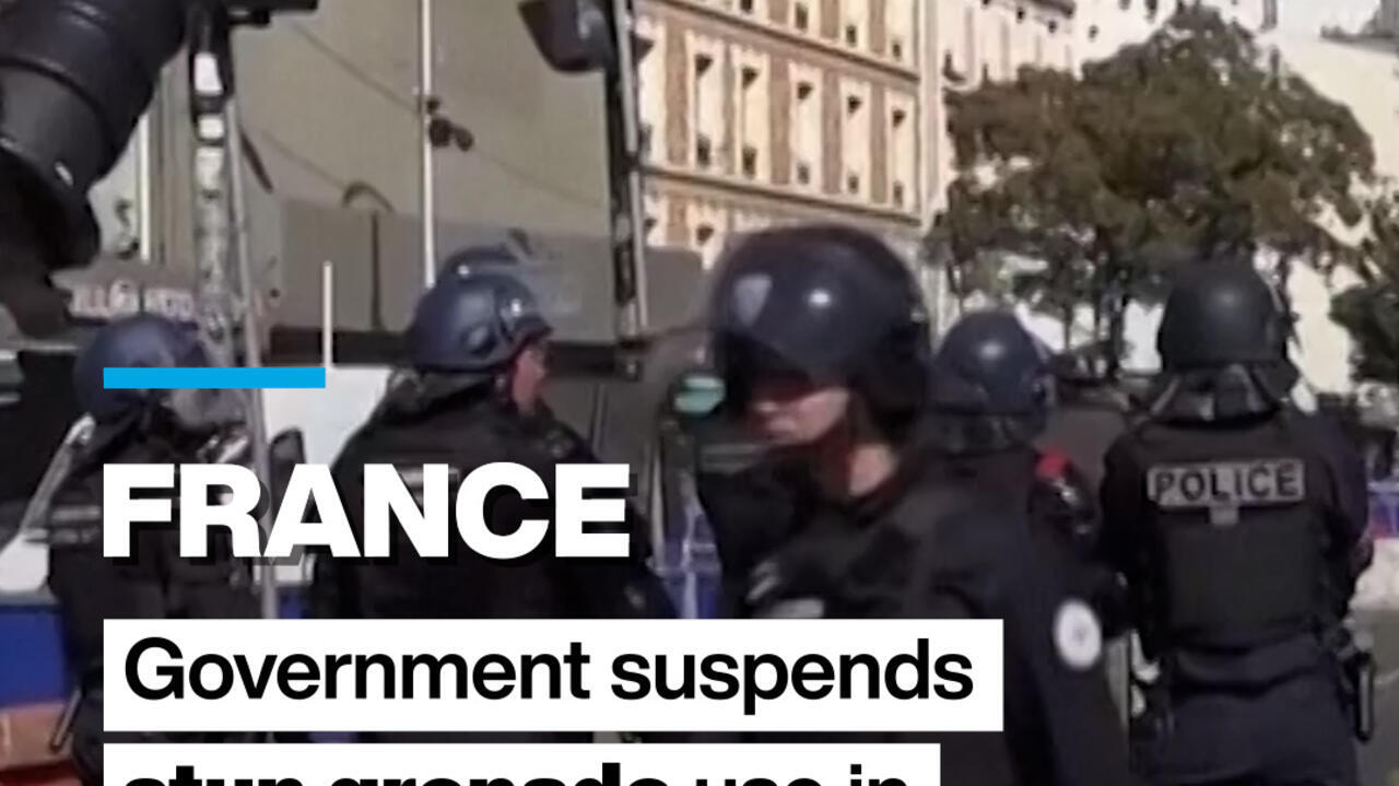 Helmeted police officers stand in a city street, with a France headline graphic over the scene.