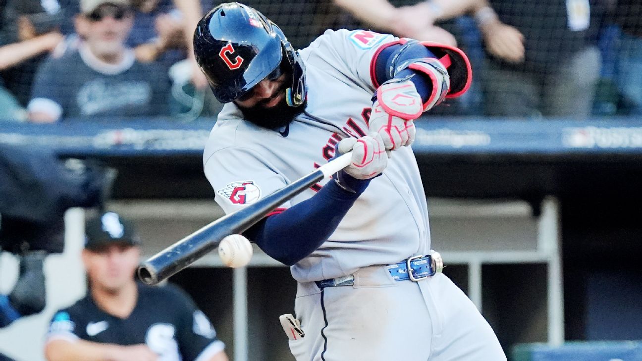 Cleveland Guardians batter swings as a baseball passes near his bat during a game.