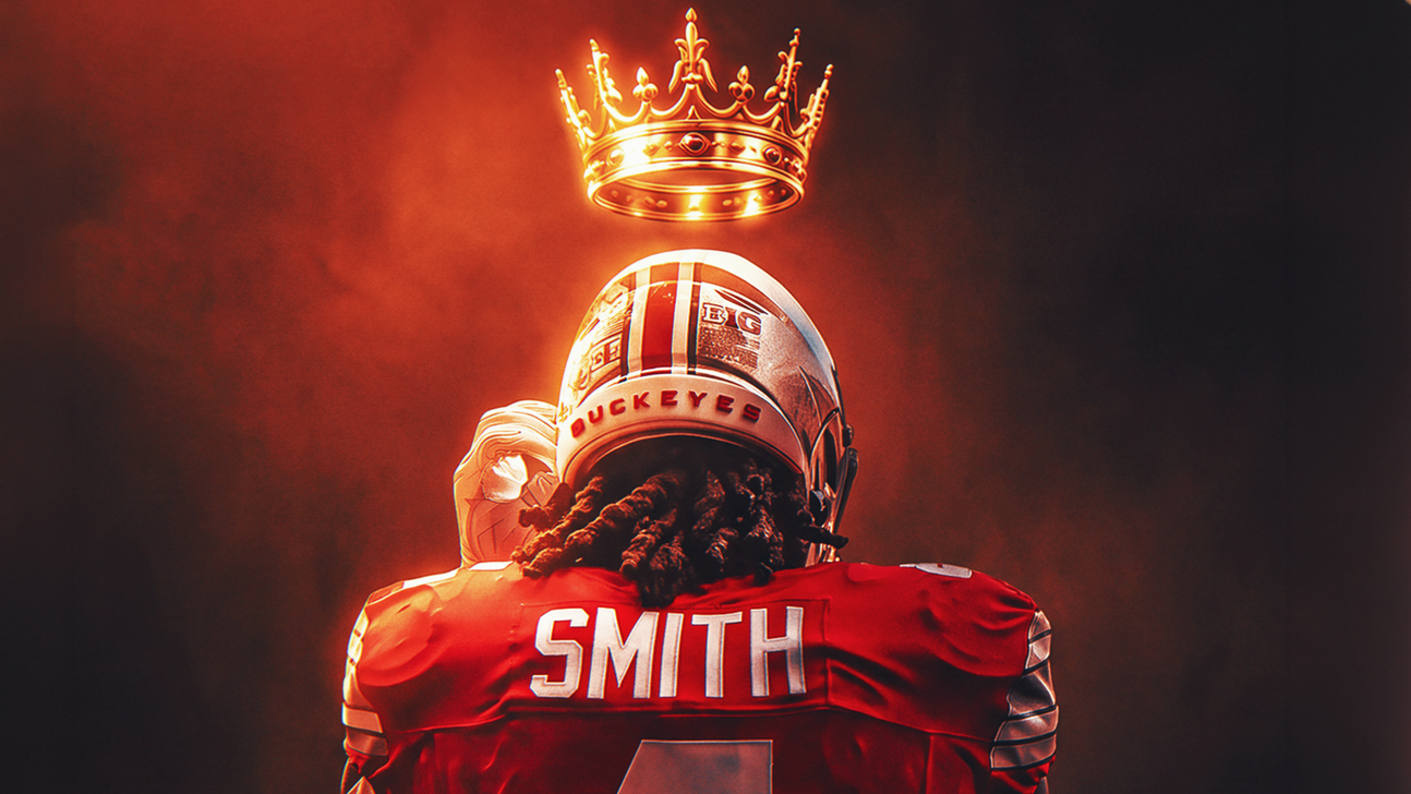Football player in a red jersey and Ohio State helmet stands beneath a glowing crown.