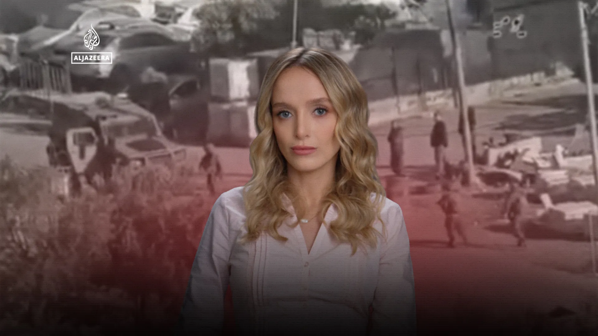 A female news presenter stands before footage of a street scene, with an Al Jazeera logo in the upper left.