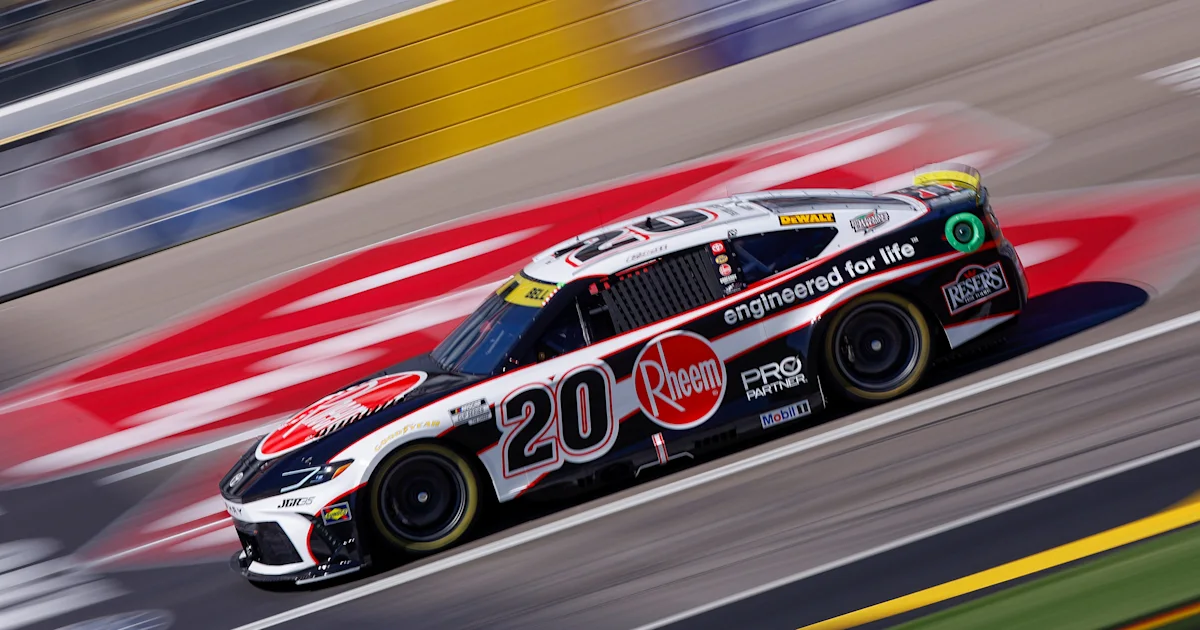 A black, white, and red No. 20 NASCAR stock car speeds along a track.