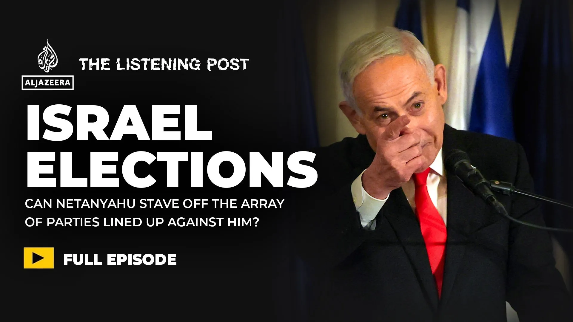 Benjamin Netanyahu gestures at a microphone beside a graphic about Israeli elections and opposition parties.