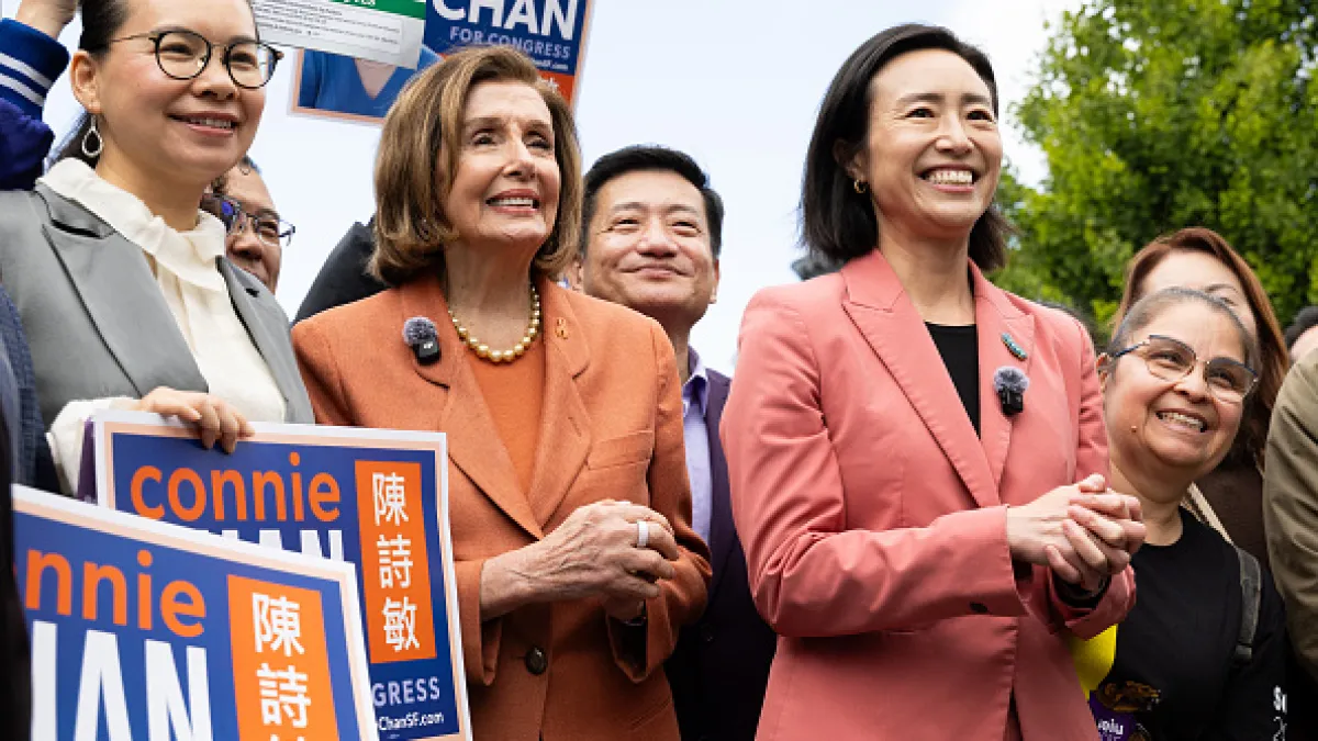 Several smiling people pose outdoors with campaign signs, including one reading “Connie Chan.”