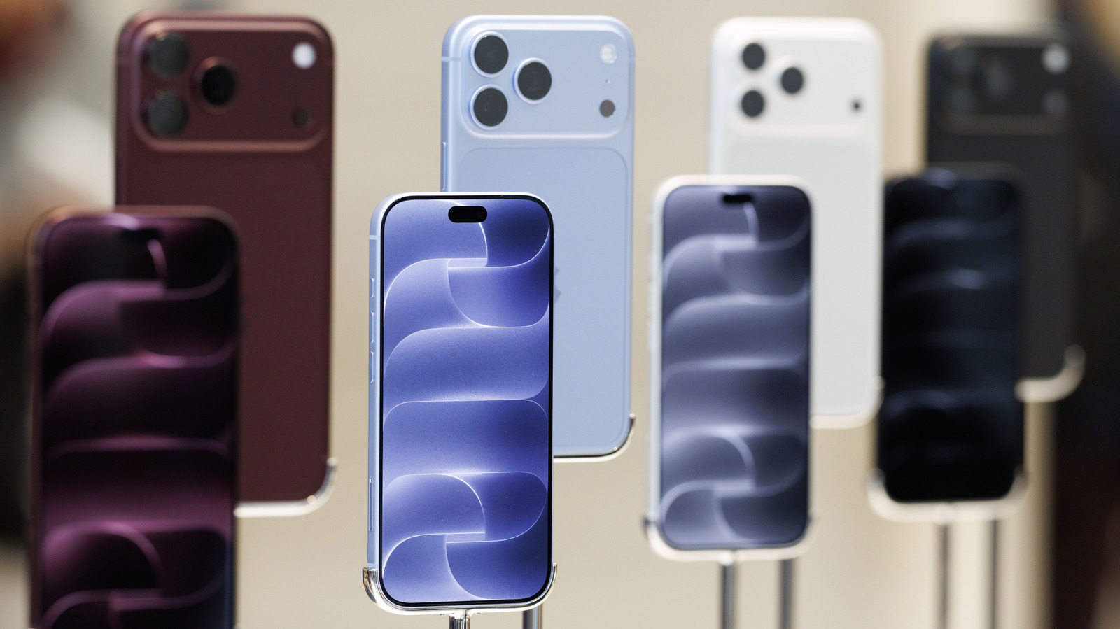 Several smartphones displayed upright, showing colorful screens and rear camera arrays.