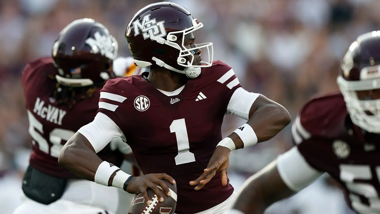 Mississippi State football player in maroon number 1 uniform holds a football during a game.