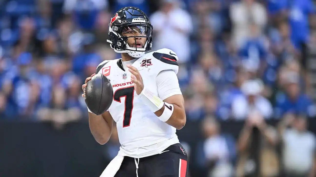 Houston Texans player in a white number 7 jersey holds a football during a game.