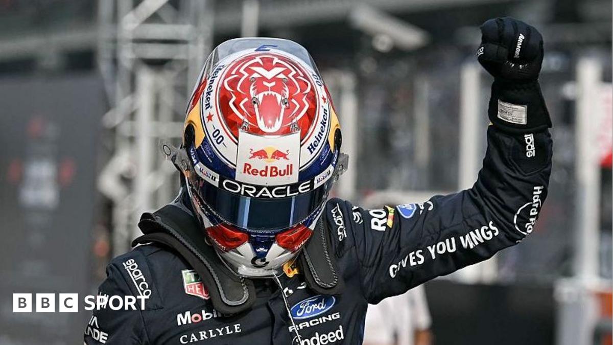 A helmeted racing driver in a dark suit raises a gloved fist, with a BBC Sport logo at lower left.