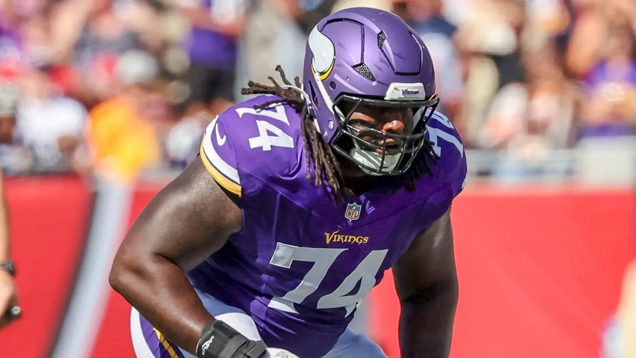 Minnesota Vikings player wearing number 74 in a purple uniform and helmet during a game.