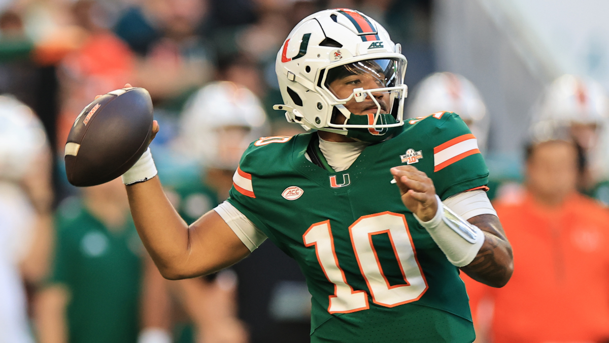 Miami quarterback in green number 10 jersey prepares to throw a football during a game.
