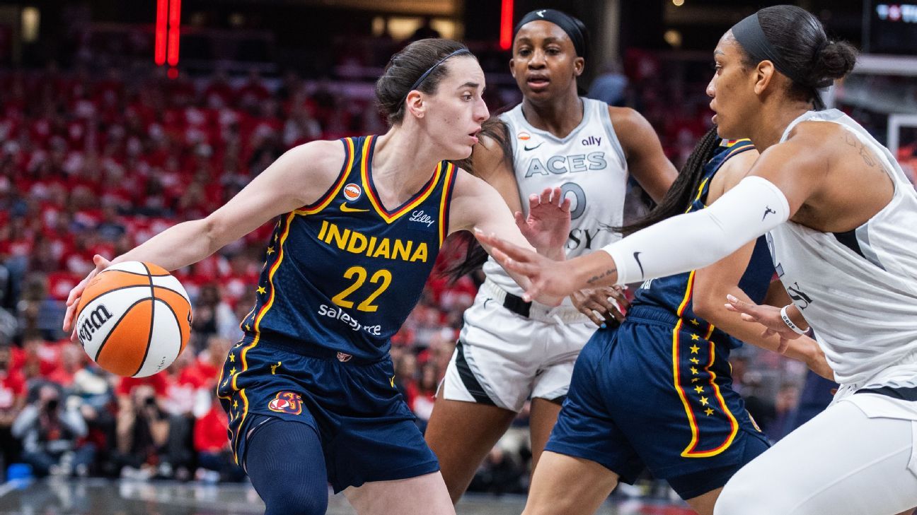Indiana player dribbles past Las Vegas defenders during a basketball game.